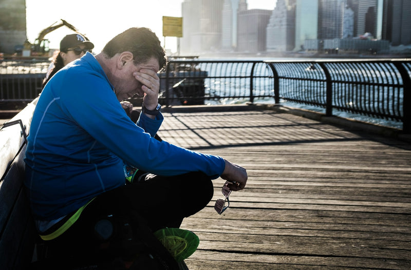 Runner sitting down to recover after a hard run