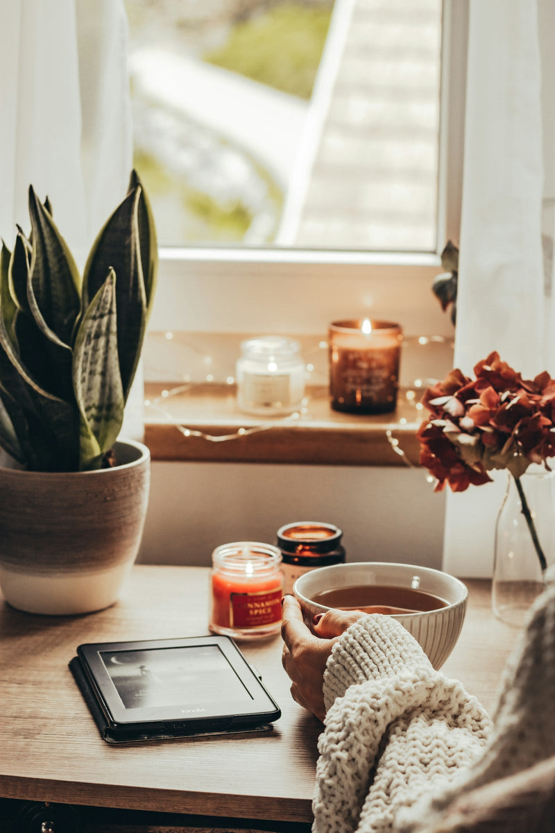 Cup of tea and candles for an evening wind-down at home
