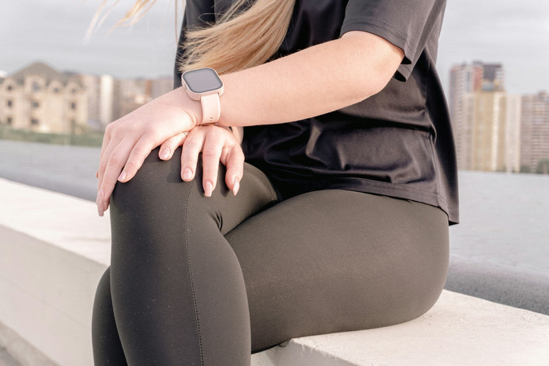 Woman holding her knee after exercise